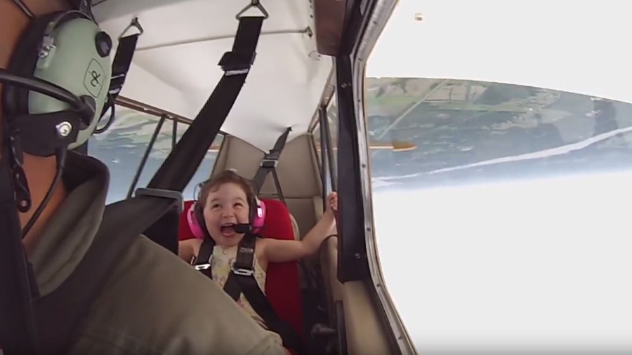 Little Léa on cloud nine as dad takes her on aerobatic adventure