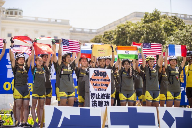 The Ride2Freedom team are presented during a Falun Gong rally on Capitol Hill in Washington, on July 16, after riding across the country. (Larry Dye/Epoch Times)
