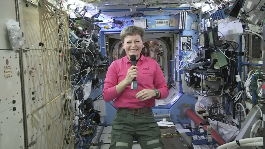 Record setting astronaut happy to spend even more time in space