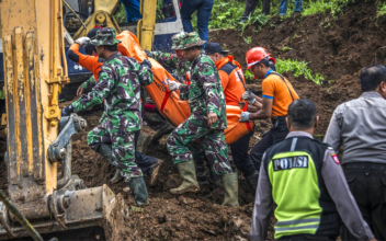 Rescuers search for dozens missing in Indonesian landslide