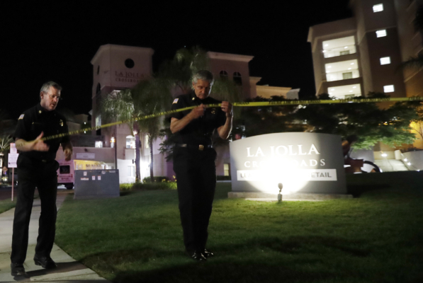 San Diego police officers work at a cordoned off La Jolla apartment after a shooting Sunday, April 30, 2017, in San Diego. (AP Photo/Gregory Bull)