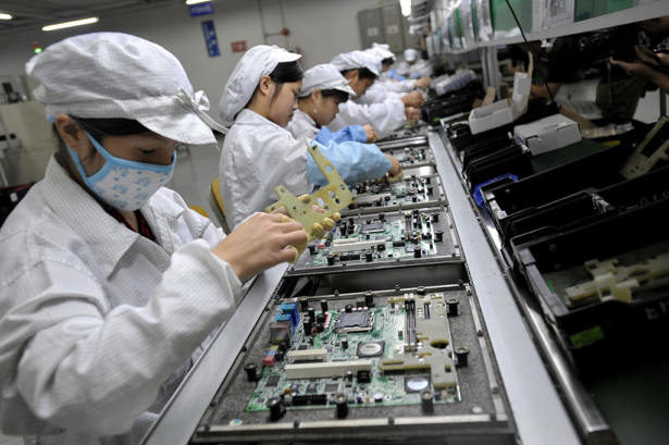 Chinese workers assemble electronic components at the Taiwanese technology giant Foxconn's factory in Shenzhen, on May 26, 2010. (AFP/AFP/Getty Images)