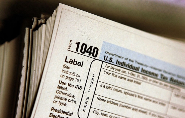 The top of a form 1040 individual income tax return for 2005 is seen atop a stack on the same at the Des Plaines Public Library in Des Plaines, Illinois, on March 23, 2006. (Tim Boyle/Getty Images)