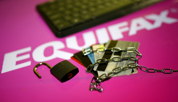 Credit cards, a chain and an open padlock is seen in front of displayed Equifax logo in this illustration taken on Sept. 8, 2017. (Dado Ruvic/Illustration via Reuters)