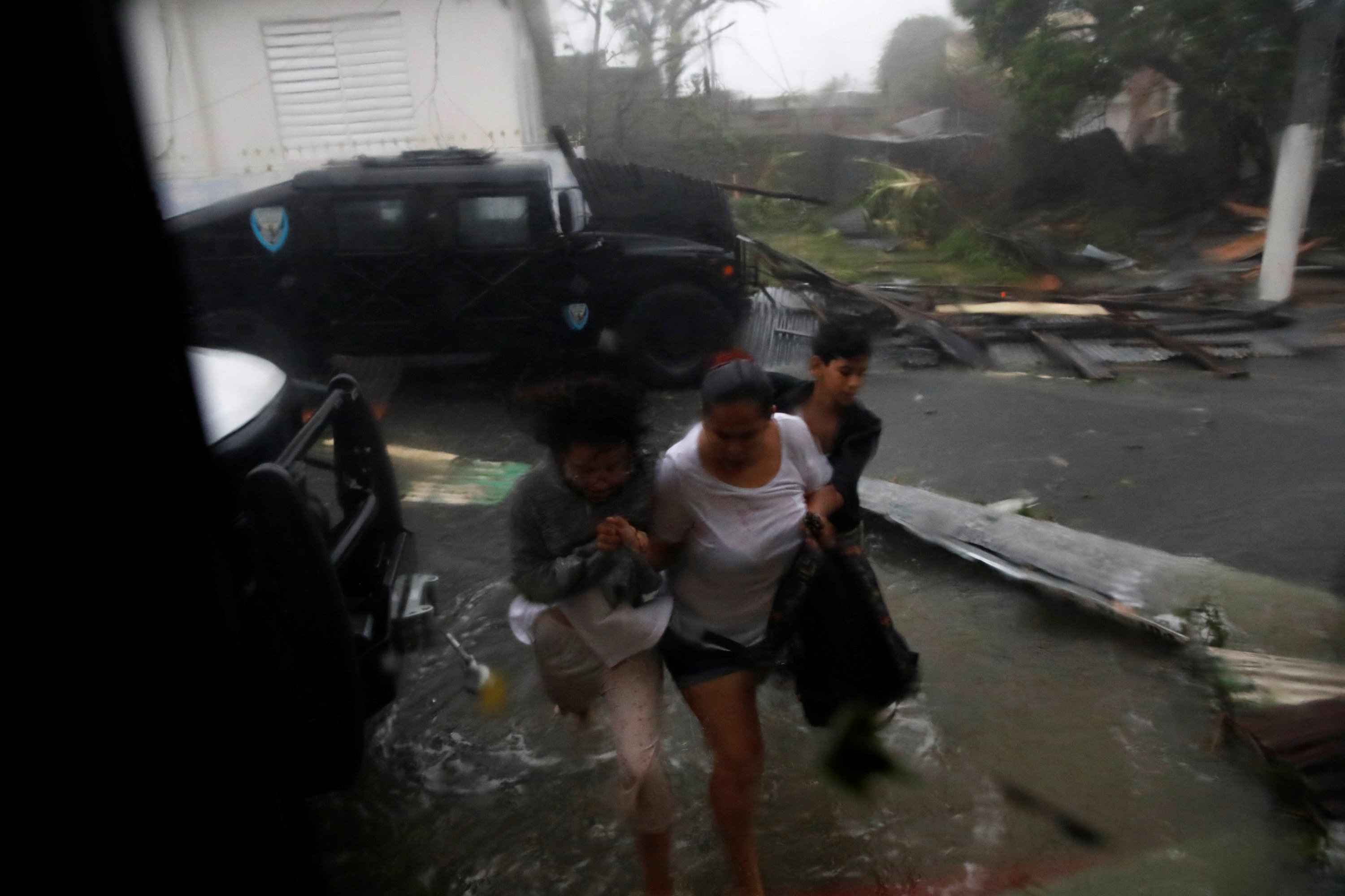 People arrive to the Emergency Operation Centre looking for shelter after the area was hit by Hurricane Maria in Guayama, Puerto Rico on Sept. 20, 2017. (REUTERS/Carlos Garcia Rawlins)
