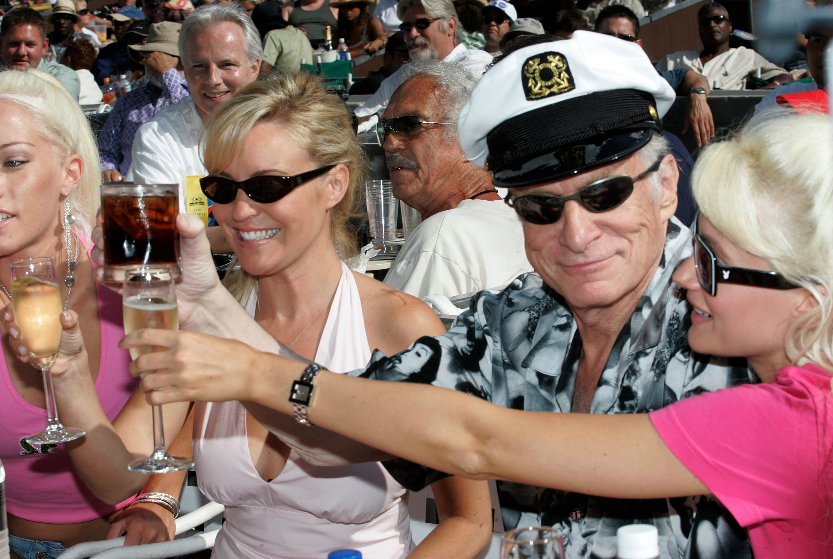 Hugh Hefner and guests toast one another as they get settled in their box seats at the 2005 Playboy Jazz Festival at the Hollywood Bowl. (REUTERS/Fred Prouser)