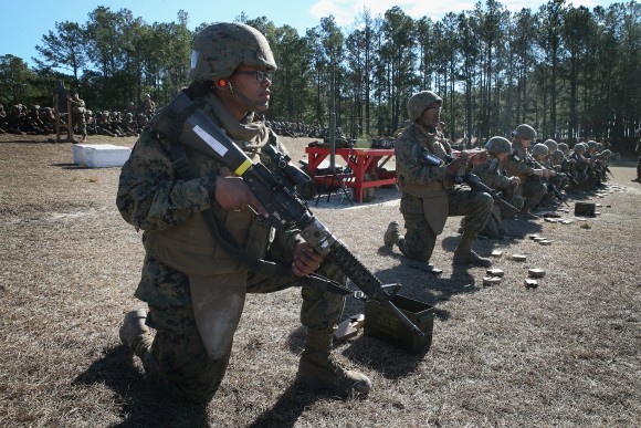 Female and male Marines line up on a firing line during a combat marksmanship course at Marine Combat Training at Camp Lejeune, N.C., on February 20, 2013. (Scott Olson/Getty Images)