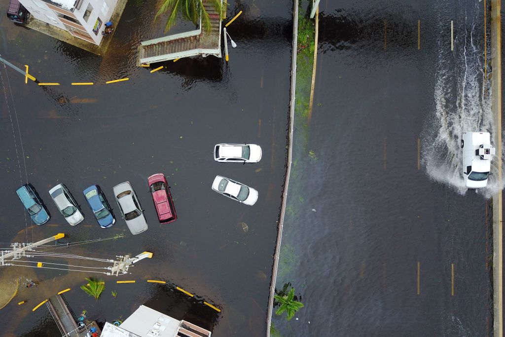 Cars drive through a flooded road in the aftermath of Hurricane Maria in San Juan, Puerto Rico, Thursday, September 21, 2017. (RICARDO ARDUENGO/AFP/Getty Images)