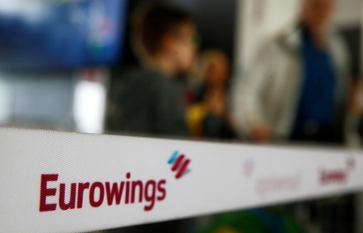 People line up behind a barrier tape of Lufthansa's budget airlines Eurowings during a 24-hour strike over pay and working conditions at Cologne-Bonn airport, Germany on Oct. 27, 2016. (REUTERS/Wolfgang Rattay)