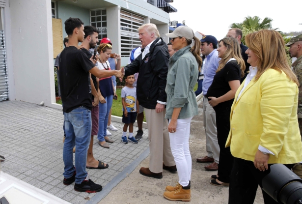 President Donald Trump talks with residents as First Lady Melania Trump (C) and U.S. Rep and Resident Commissioner of Puerto Rico Jenniffer Gonzalez (R) look on as the president visits areas damaged by Hurricane Maria in Guaynabo, Puerto Rico, on Oct. 3, 2017. (Jonathan Ernst/Reuters)
