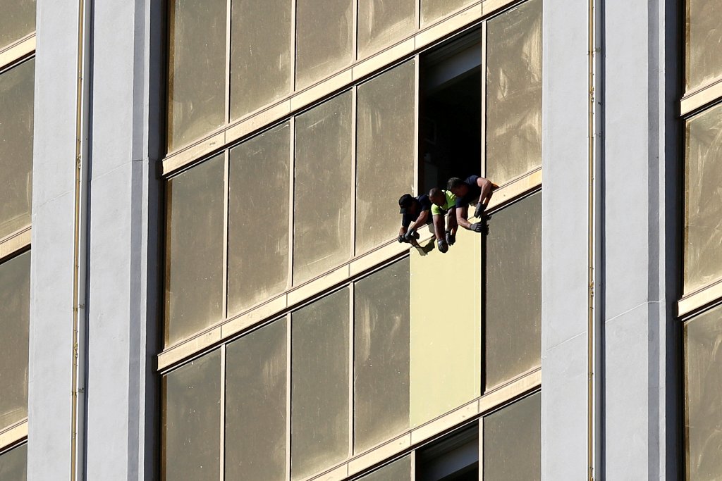 Workers board up a broken window at the Mandalay Bay hotel, where shooter Stephen Paddock conducted his mass shooting along the Las Vegas Strip, in Las Vegas, Nevada, U.S., October 6, 2017. (REUTERS/Chris Wattie/File Photo)