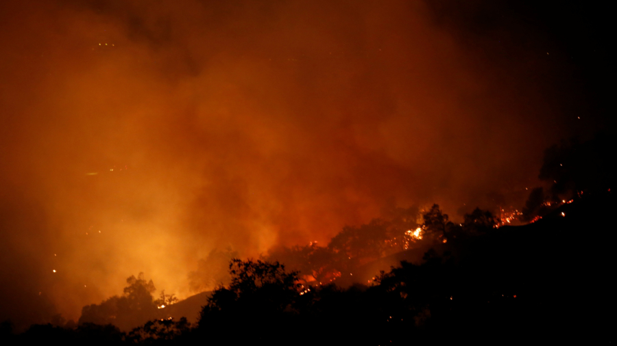 Fierce winds stir deadly California wildfires as teams search for victims