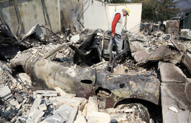 Dan Mufson searches through the remains of his home of 20 years after it was destroyed by a wildfire in Napa. (REUTERS/Jim Urquhart)