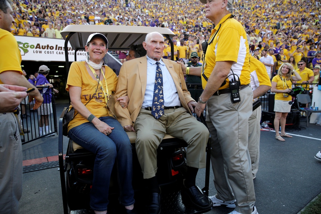 In this Sept. 20, 2014, file photo, NFL great and LSU alumnus Y.A. Tittle, center, arrives in Tiger Stadium in the first half of an NCAA college football game between LSU and Mississippi State, in Baton Rouge, La.  (AP Photo/Gerald Herbert)