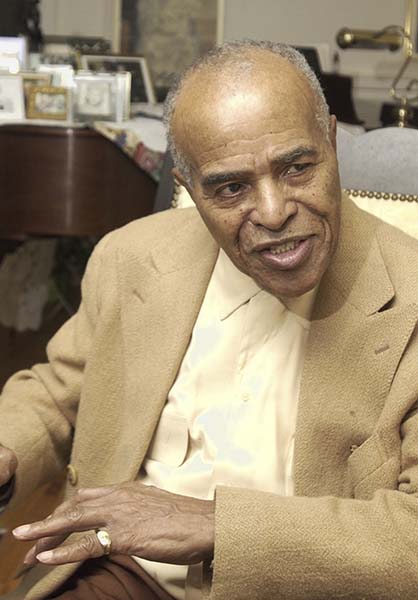 FILE - In this Jan. 13, 2004 photo, Jazz singer Jon Hendricks talks about his career in jazz at his home in Toledo, Ohio. (AP Photo/Tony Dejak, File)