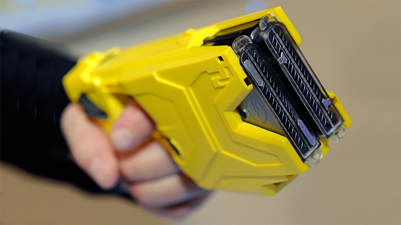 A two-shot Taser can strike multiple targets, as these officers learned the hard way. (Ethan Miller/Getty Images)