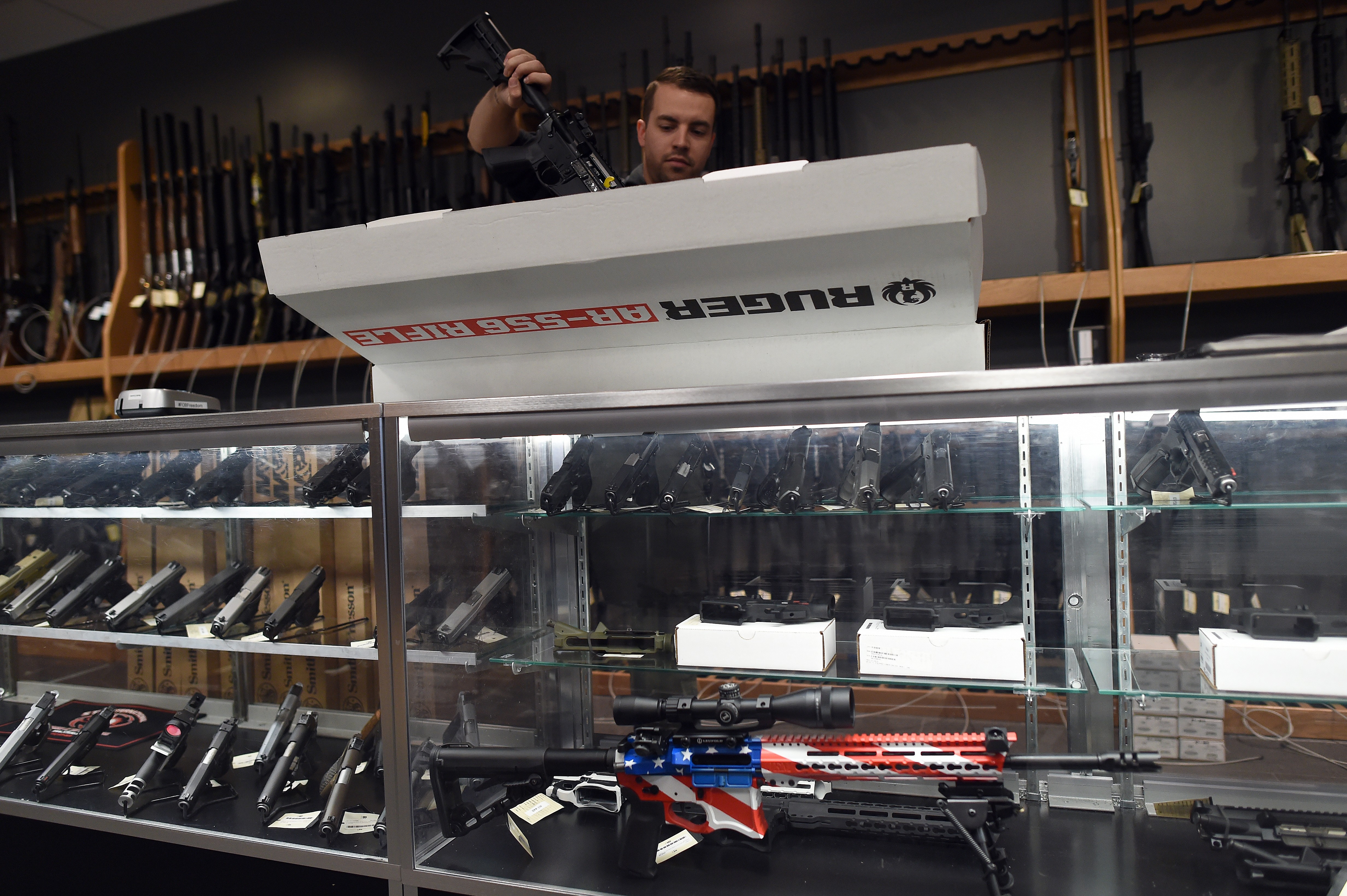 An employee un boxes a Ruger AR-556 rifle at the RTSP shooting range in Randolph, New Jersey on December 9, 2015.(Jewel Samad/AFP/Getty Images)