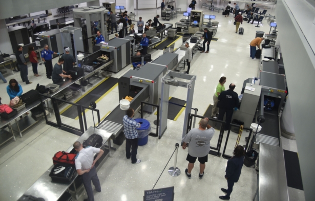 US Transportation Security Administration (TSA) officers inspect airline passengers before they board their flights, at LambertSt. Louis International Airport in St Louis, Missouri, Oct. 10, 2016. (Robyn Beck/AFP/Getty Images)
