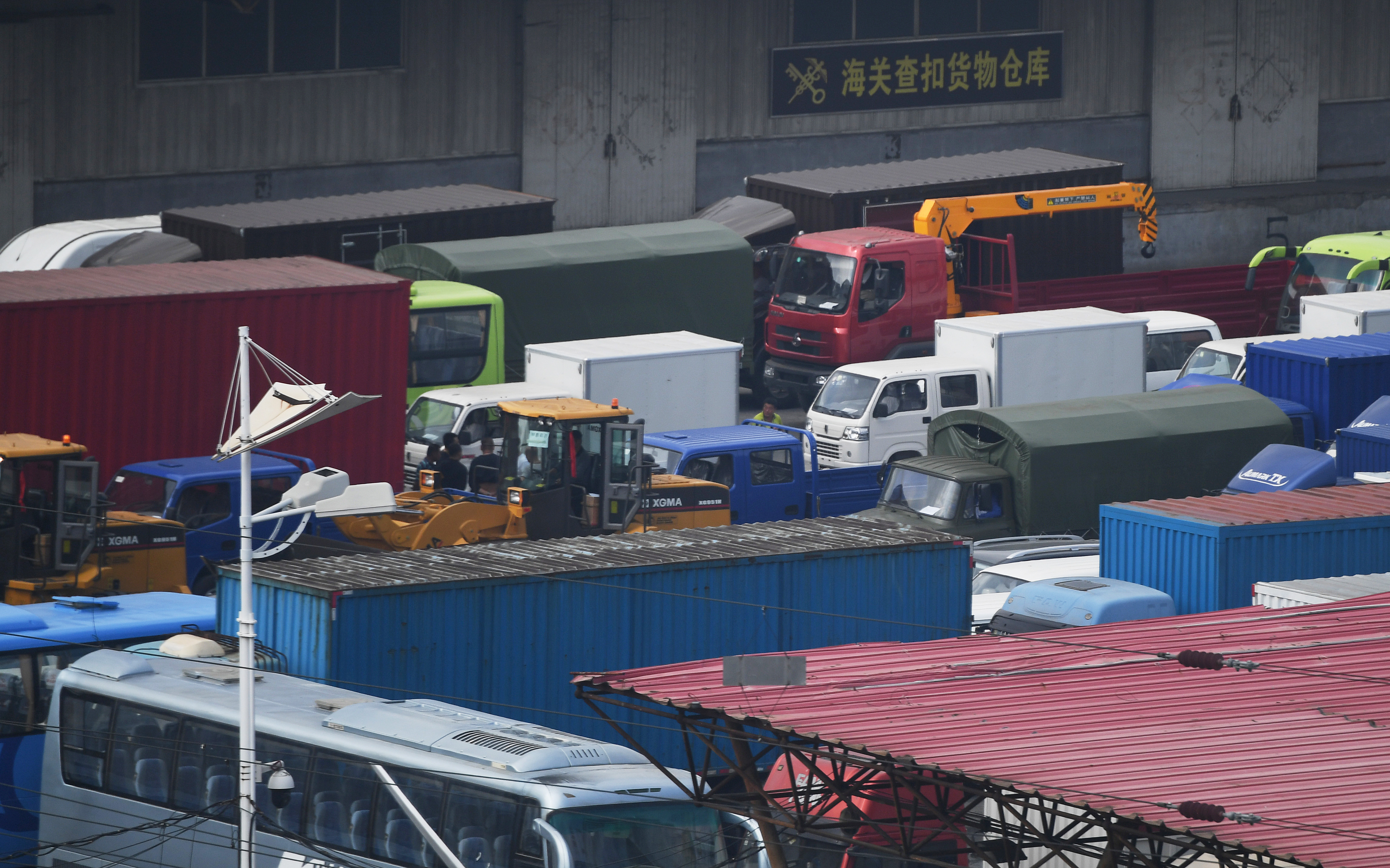 Trucks wait in the Chinese border city of Dandong, in China's northeast Liaoning province, before crossing the Friendship Bridge to the North Korean town of Sinuiju on Sept. 5, 2017. (GREG BAKER/AFP/Getty Images)