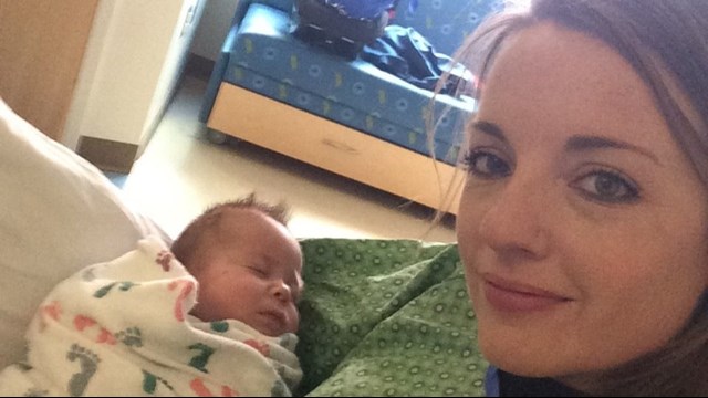 Officer Emily Hitchings holds Axel Winch. (Aurora Police Department)