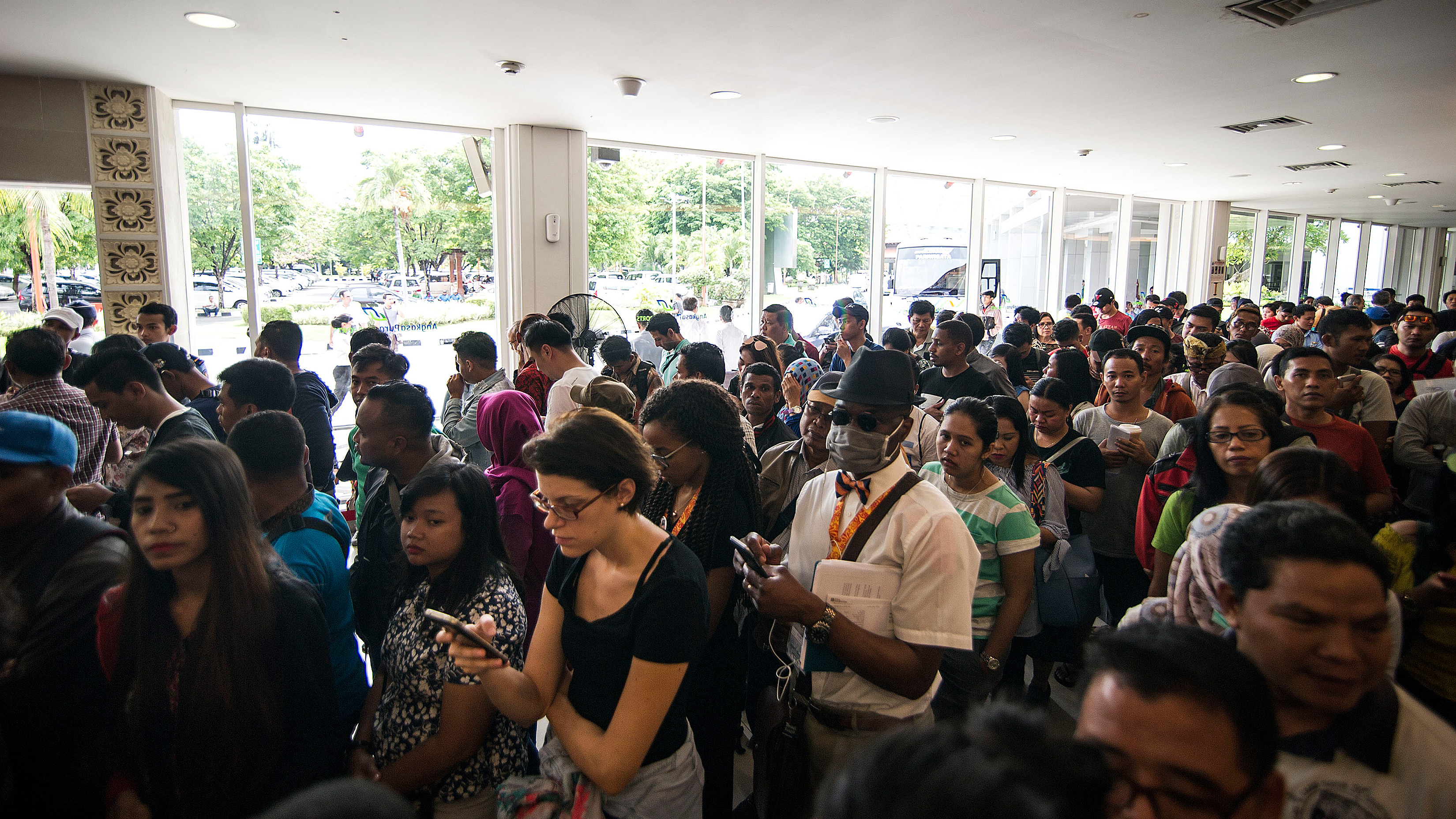 Passengers gather at the Denpasar International airport in Denpasar, Bali to wait for possible flights out following Mount Agung's volcano eruption on Nov. 28, 2017. (Juni Kriswanto/AFP/Getty Images)