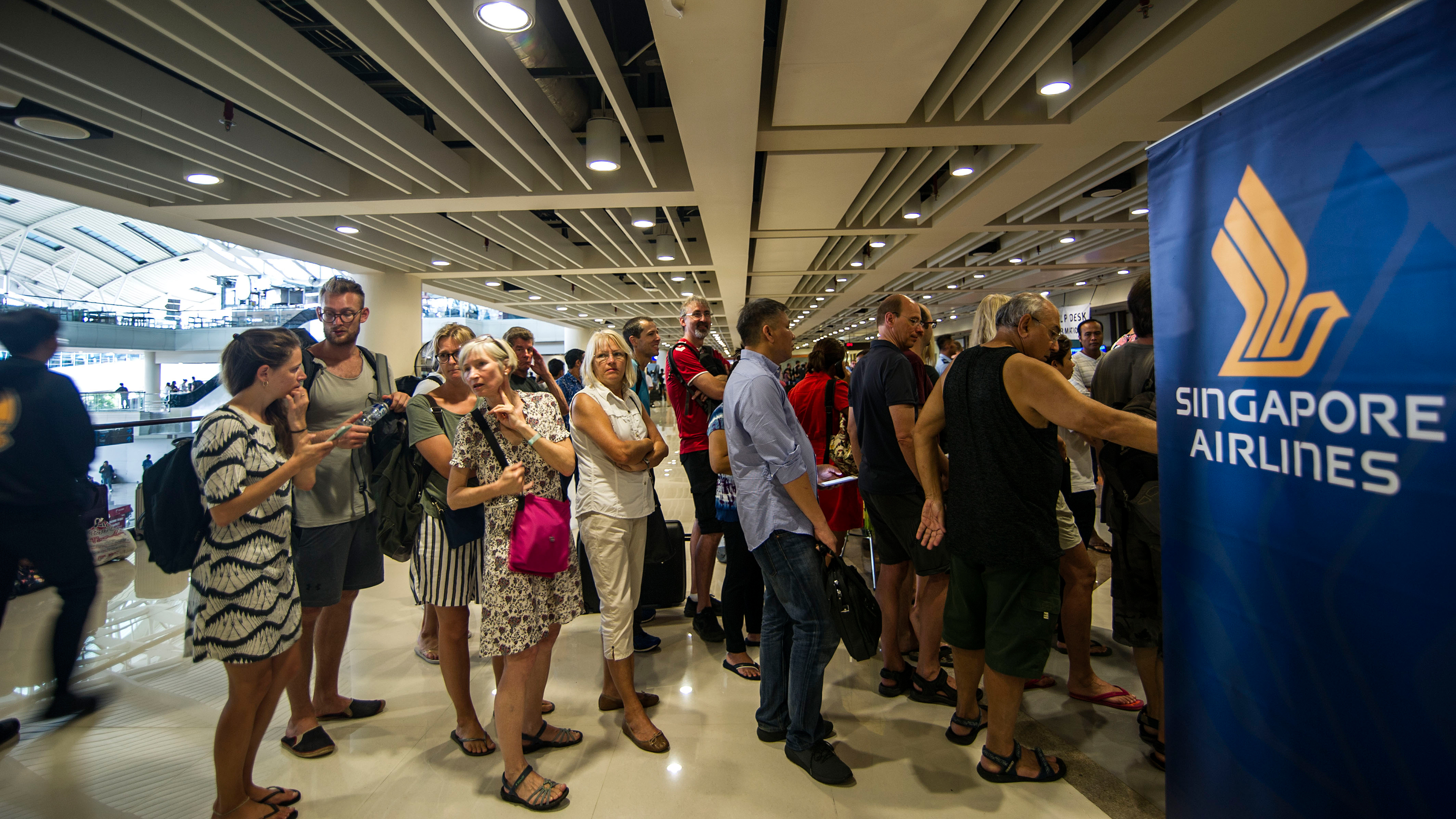 Passengers seek information about rescheduled flights out of Denpasar International airport in Denpasar, Bali on Nov. 28, 2017. (Juni Kriswanto/AFP/Getty Images)