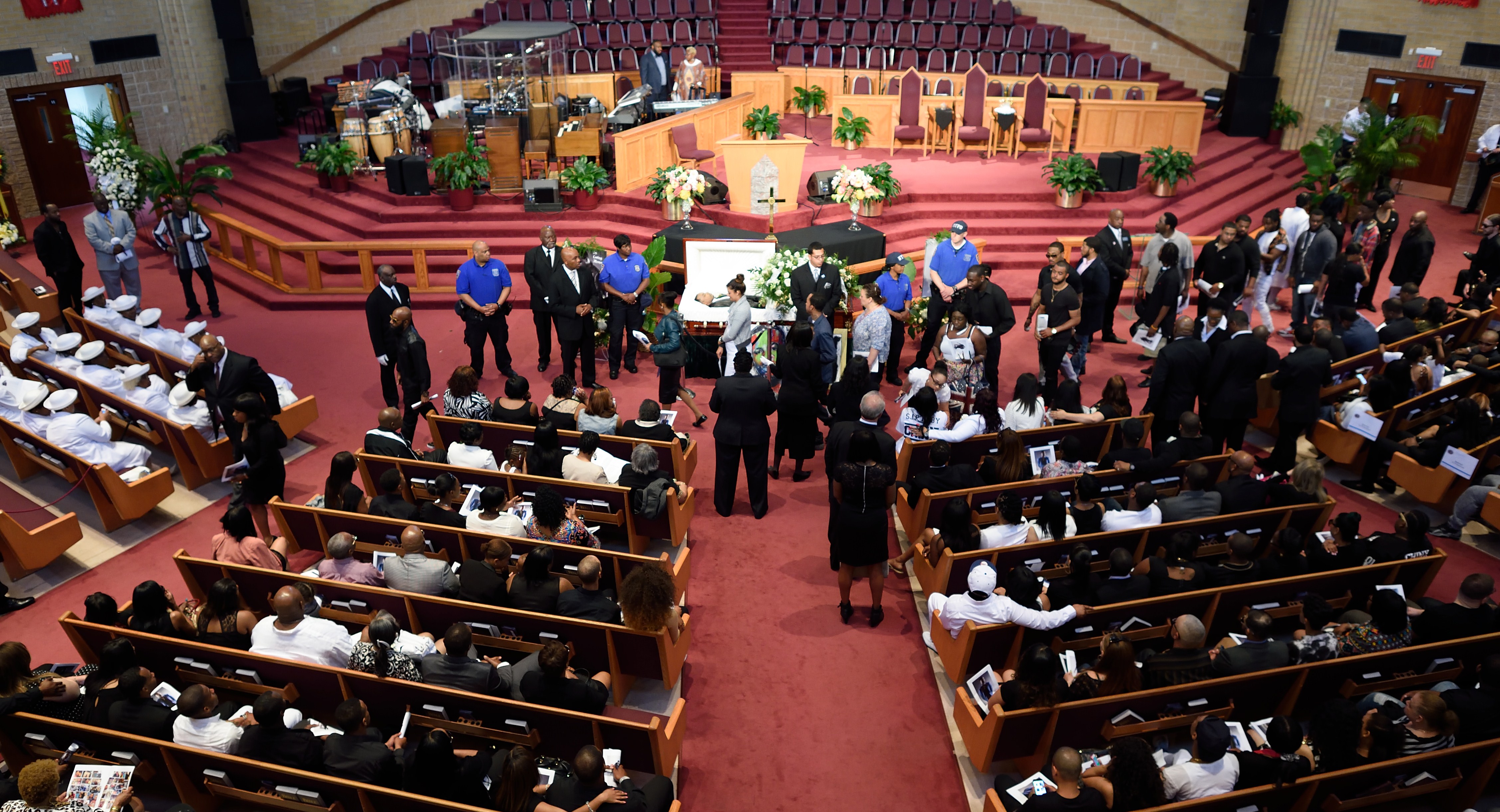 Mourners pass by the body of Rapper Chinx during his wake and funeral at Greater Allen A.M.E church May 26, 2015 in New York., a.k.a. Chinx was killed May 17 in a drive-by shooting in Queens. (Don Emmert/AFP/Getty Images)