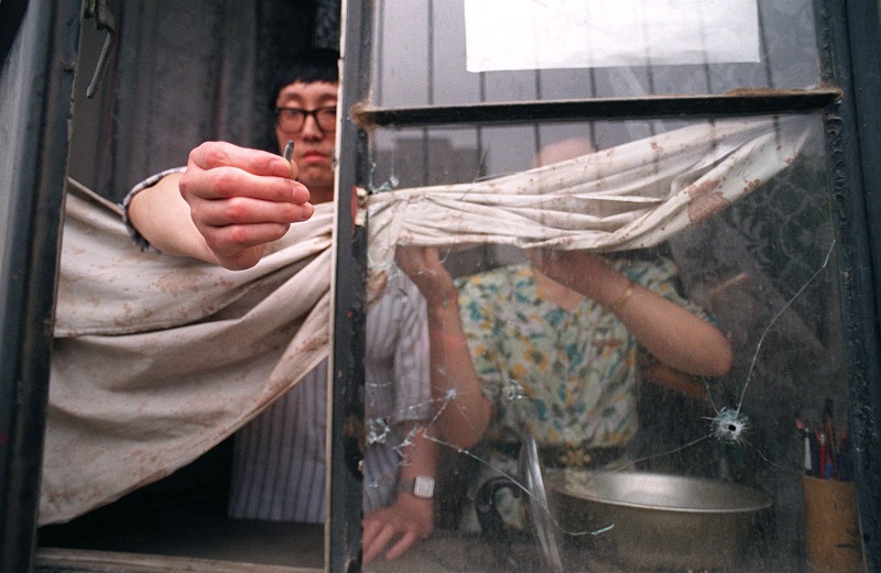 A Beijing resident on the west side of Tiananmen Square shows a bullet slug fired by the PLA that went through his flat's widow in central Beijing in early June, 1989. (Manuel Ceneta/AFP/Getty Images)