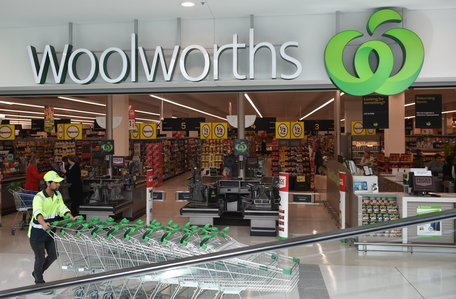 A worker pushes shopping trolleys at a Woolworths store in Sydney on Aug. 25, 2016. (Peter Parks/AFP/Getty Images)