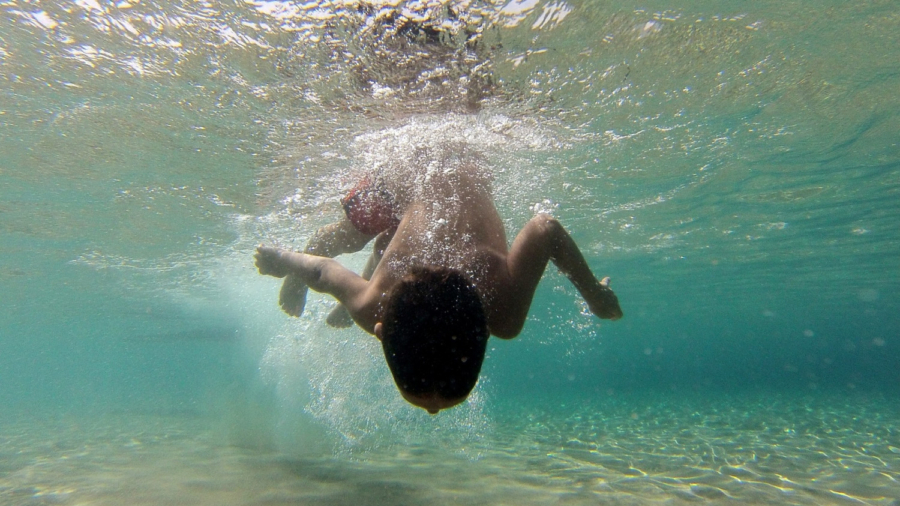 Drone Operator Screams at Swimming Boy Unaware of Mortal Danger