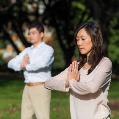 People practice the Falun Gong, also named Falun Dafa, exercises in a park.