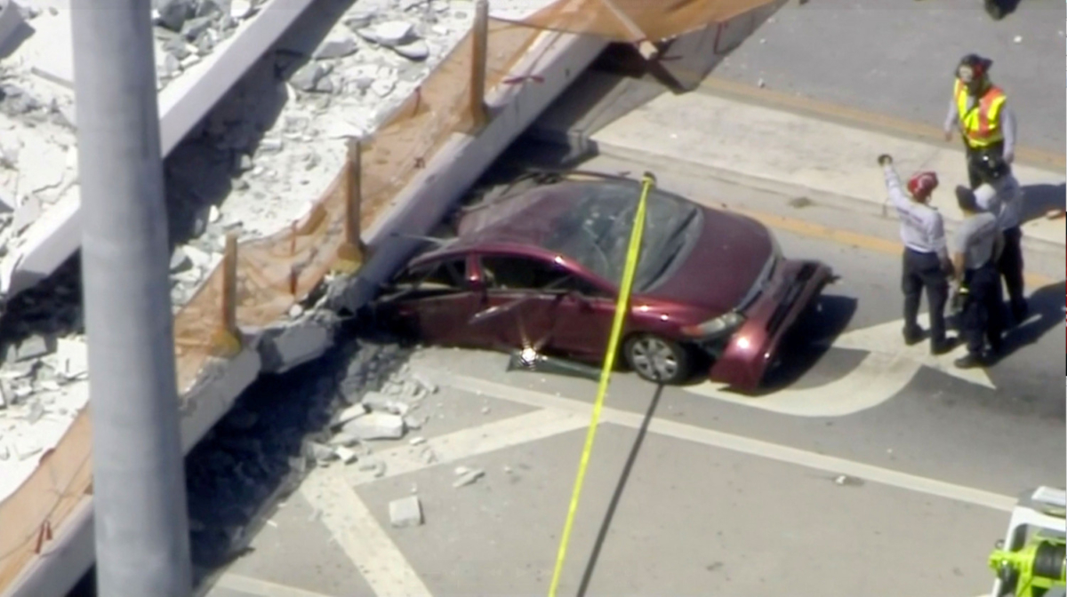 Emergency crews look for victims at the scene of a collapsed pedestrian bridge at Florida International University in Miami, Florida, U.S., March 15, 2018 in this still image from video. (Courtesy of WTVJ-NBCMiami.com/Handout via REUTERS)