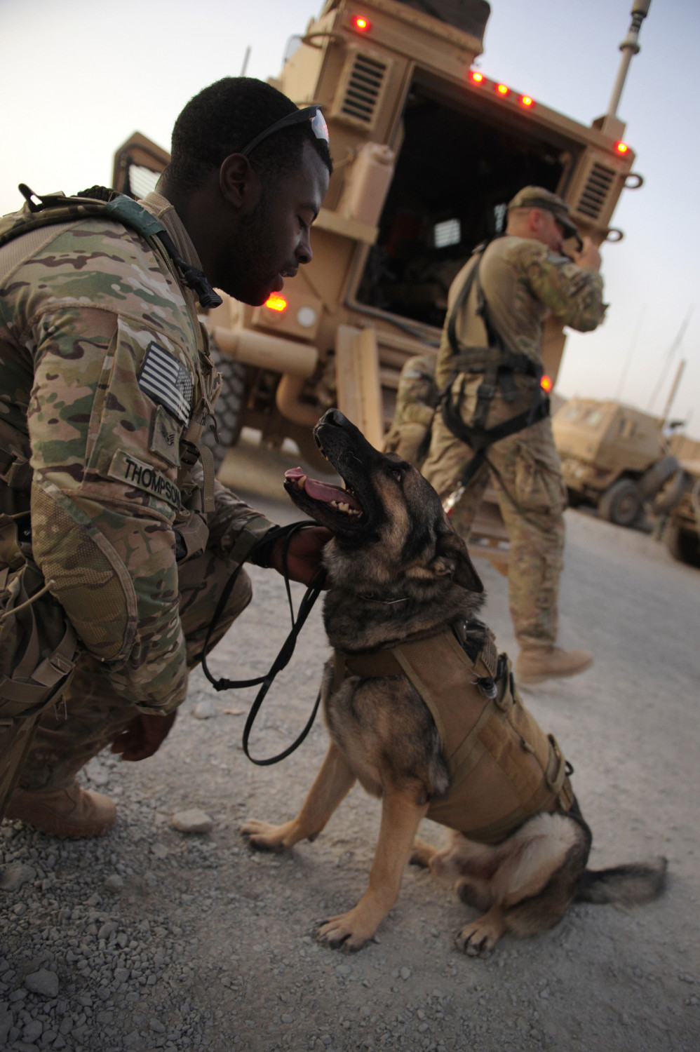 US Army Staff Sergeant Lindsey Thompson holds Mayo, a German Shepherd, in Kandahar, Afghanistan, on Aug. 14, 2011. (Romeo Gacad/AFP/Getty Images)