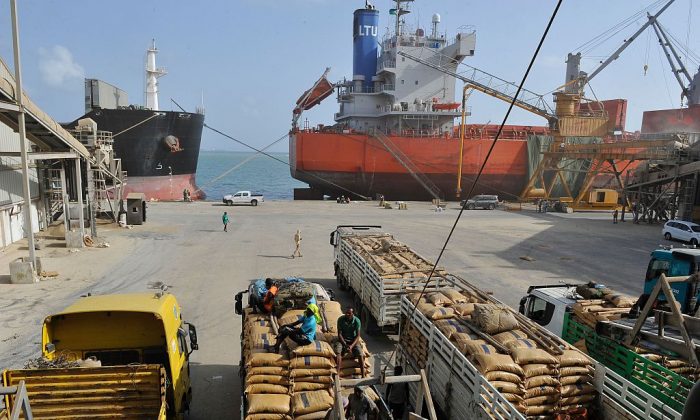 Casual labourers load goods in the port of Djibouti, on March 27, 2016. (Simon Maina/AFP/Getty Images)