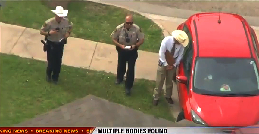 Law enforcement officials investigate the red Ford with out-of-state plates. (Fox screenshot)