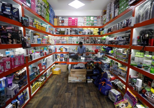 An Afghan shopkeeper works on his laptop at his online shop in Kabul, Afghanistan June 4, 2018. Picture taken June 4, 2018. (Reuters/Omar Sobhani)