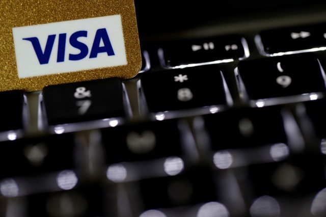 A Visa credit card is seen on a computer keyboard in this picture illustration taken on Sept. 6, 2017. (Philippe Wojazer/Illustration/Reuters)