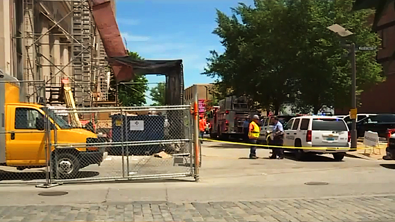 City officials speak with construction workers at the site of the accident. (Fox screenshot)