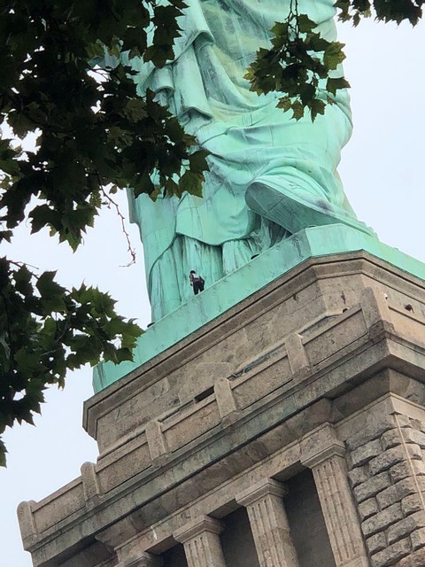 A protester is seen on the Statue of Liberty in New York, New York, on July 4, 2018 in this picture obtained from social media. (Danny Owens/Reuters)