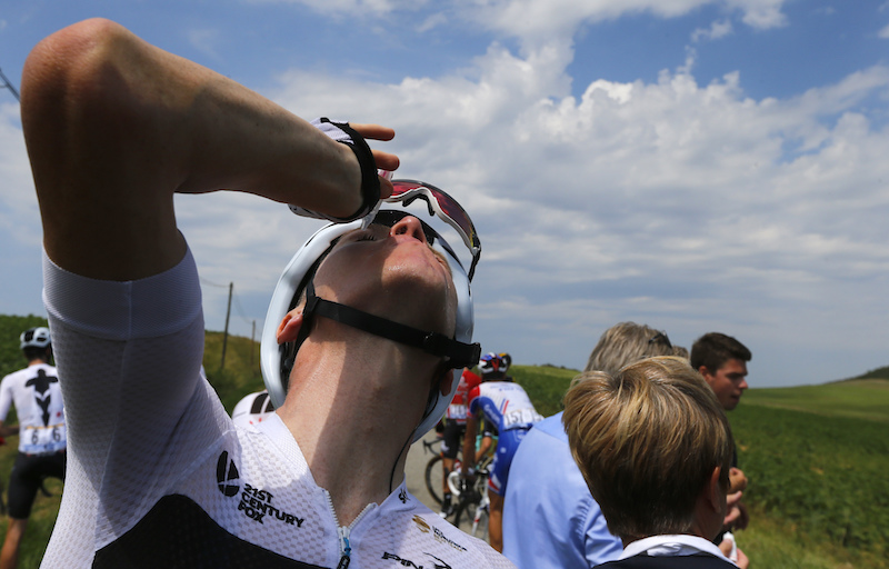 Britain's Chris Froome treats his eyes for tear gas or pepper spray sprayed on the peloton when a farmer's protest interrupted during the sixteenth stage of the Tour de France cycling race over 218 kilometers (135.5 miles) with start in Carcassonne and finish in Bagneres-de-Luchon, on July 24, 2018. (AP Photo/Peter Dejong)