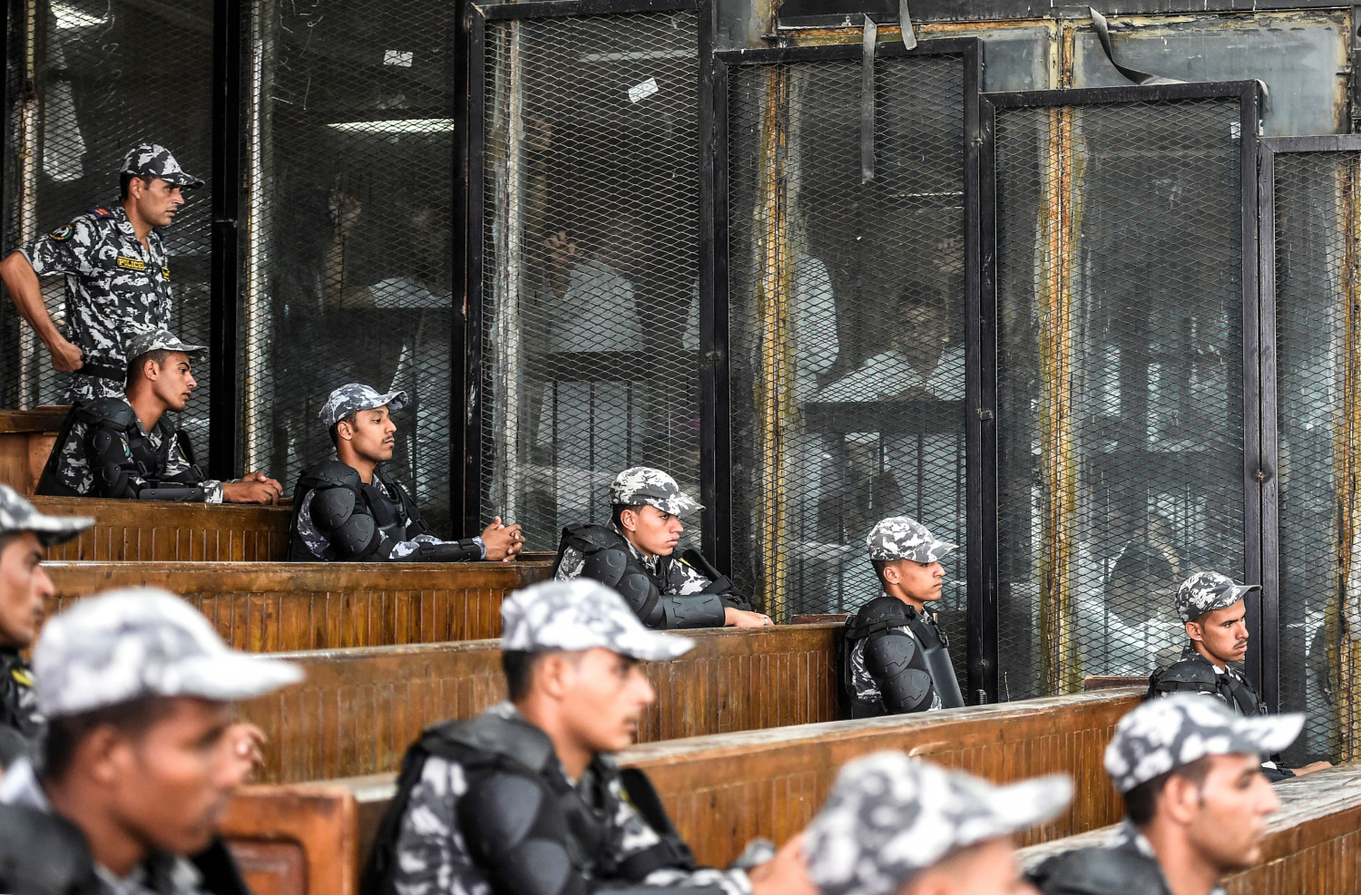 Members of Egypt's banned Muslim Brotherhood are seen inside a glass dock during their trial in the capital Cairo on July 28, 2018. (KHALED DESOUKI/AFP/Getty Images)