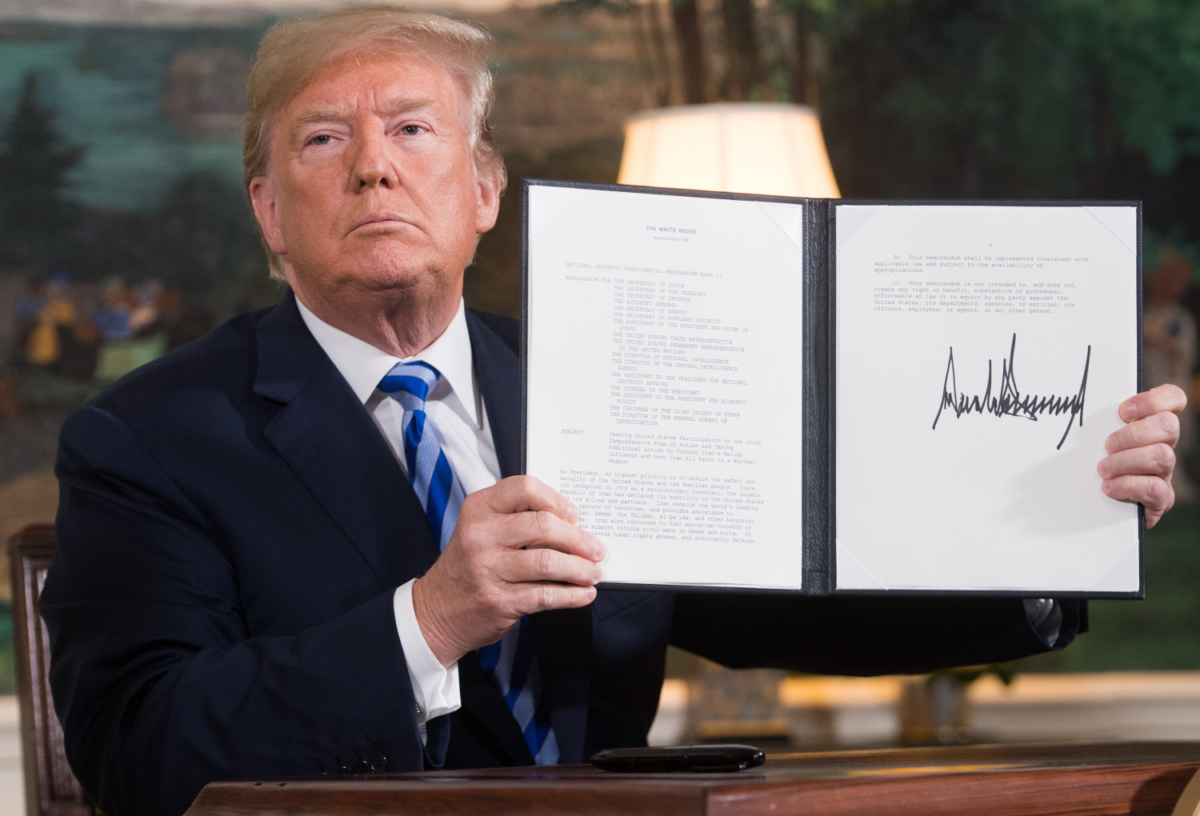 U.S. President Donald Trump signs a document reinstating sanctions against Iran after announcing the U.S. withdrawal from the Iran Nuclear deal, in the Diplomatic Reception Room at the White House in Washington, DC, on May 8, 2018. (SAUL LOEB/AFP/Getty Images)