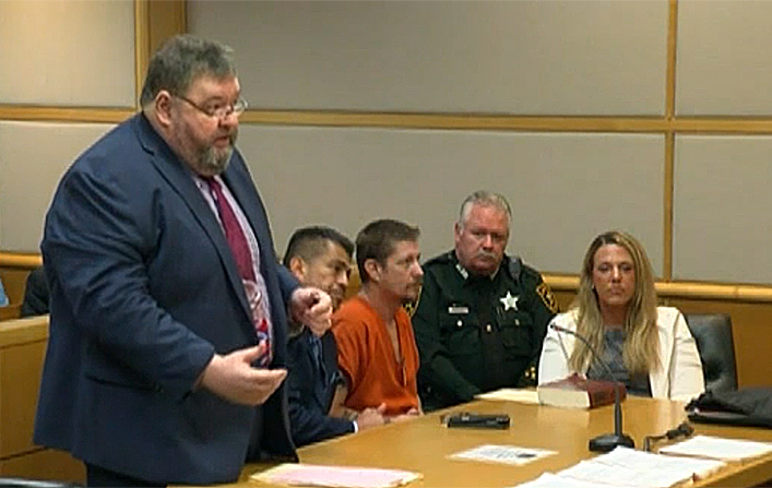 Michael Drejka (orange jumpsuit) listens while his lawyer, John Trevena, (Left) pleads for lowered bail. (Fox screenshot)