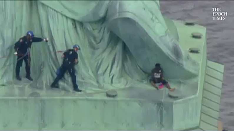 Statue of Liberty Protester Has Anti-US Message