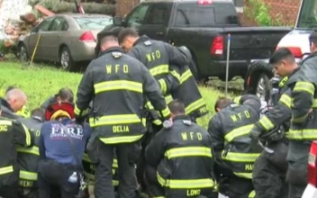 Firefighters Kneel and Pray at Site Where Mother and Baby Killed by Hurricane Florence