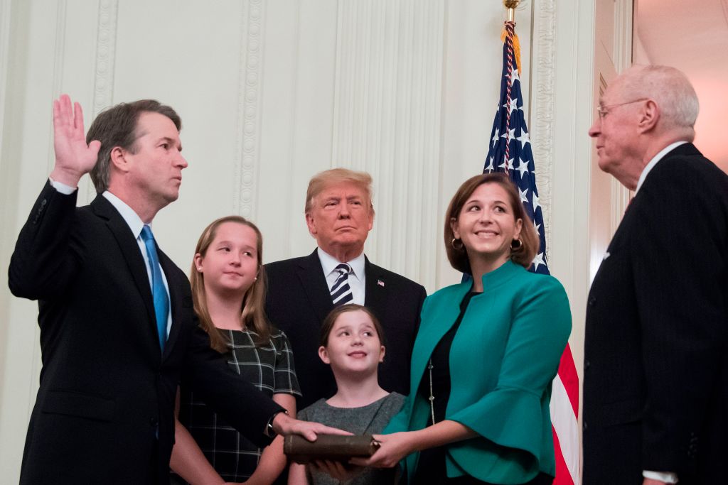 Brett Kavanaugh (L) is sworn in as Associate justice of the Supreme Court by retired Associate Justice Anthony Kennedy (R) before wife Ashley Estes Kavanaugh (2nd-R), daughters Margaret (2nd-L) and Elizabeth (C), and President Donald Trump at the White House on Oct. 8, 2018,. (Jim Watson/AFP/Getty Images)