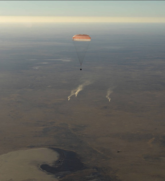 The landing jets fire as the Soyuz MS-08 spacecraft comes in for a landing on Oct. 4, 2018, in Kazakhstan. (Bill Ingalls/NASA)