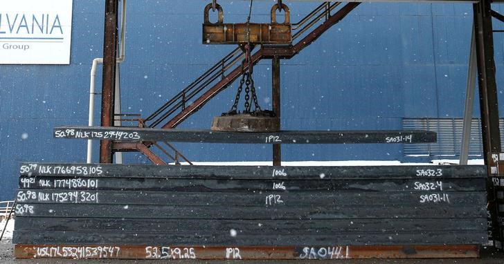 An overhead crane places a steel slab for storage at the Novolipetsk Steel PAO steel mill in Farrell, Penn., on Mar. 9, 2018. (aron Josefczyk/Reuters)