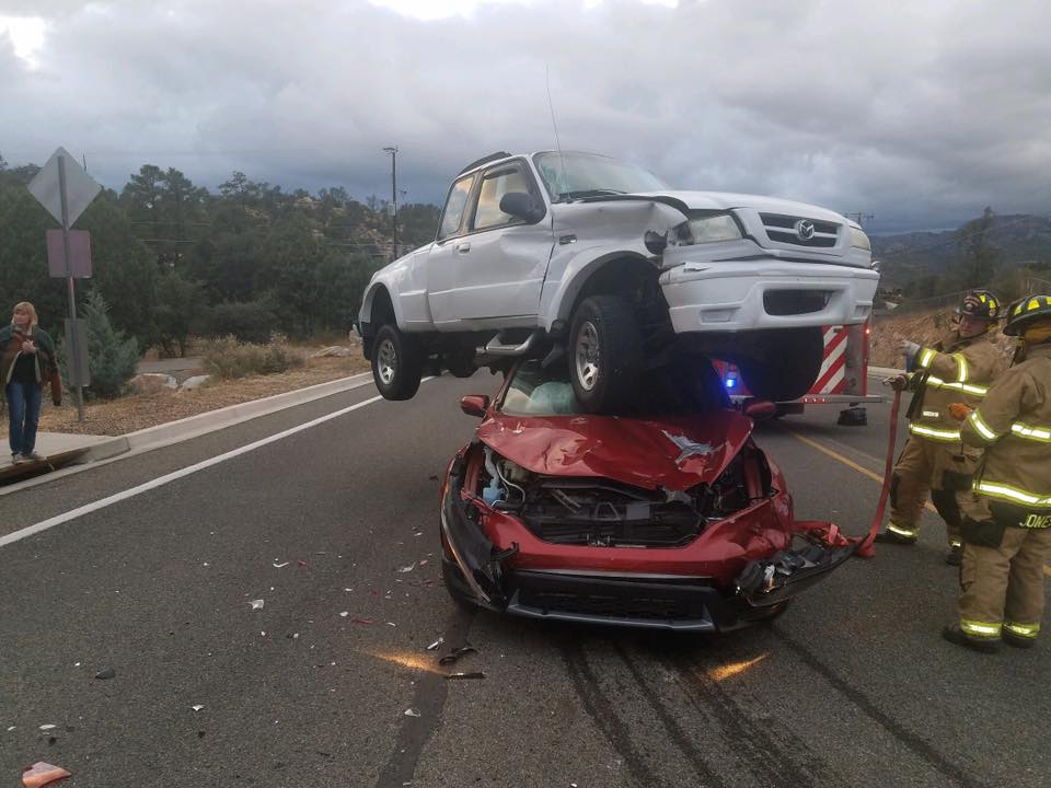 A car crash in Prescott, Ariz., ended with a truck on top of a car, on Oct. 7, 2018. (Prescott Fire Department)