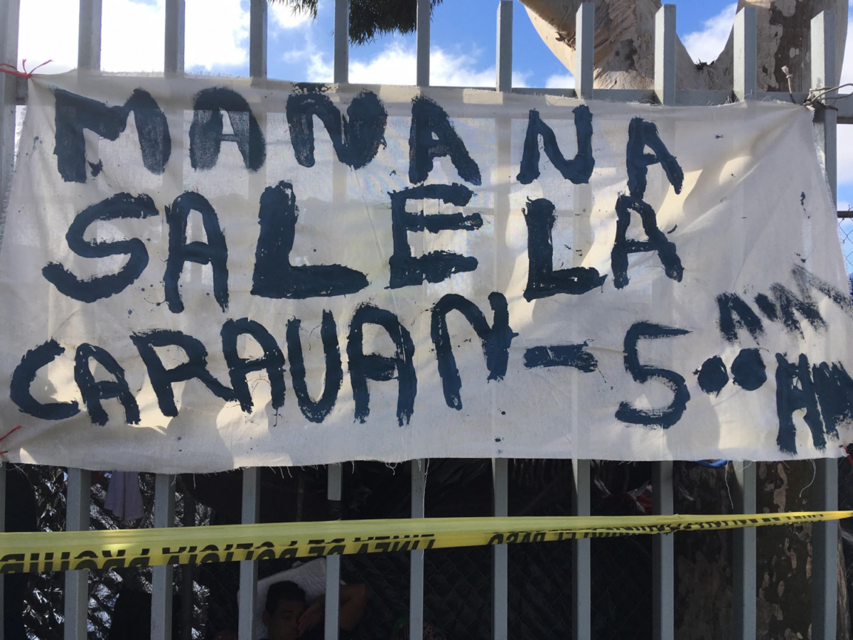 A hand-painted sign on the fence around the sports complex where up to 5,000 migrants are camping out in Tijuana Mexico, on Nov. 24, 2018. (Charlotte Cuthbertson/The Epoch Times)